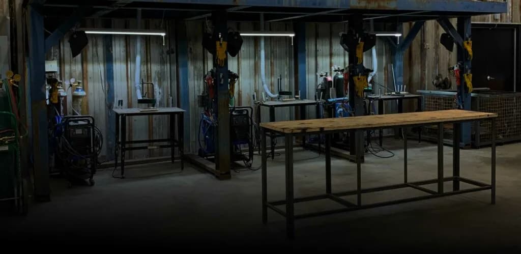 The metalshop at Triumph Workshop with welders and a CNC plasma table